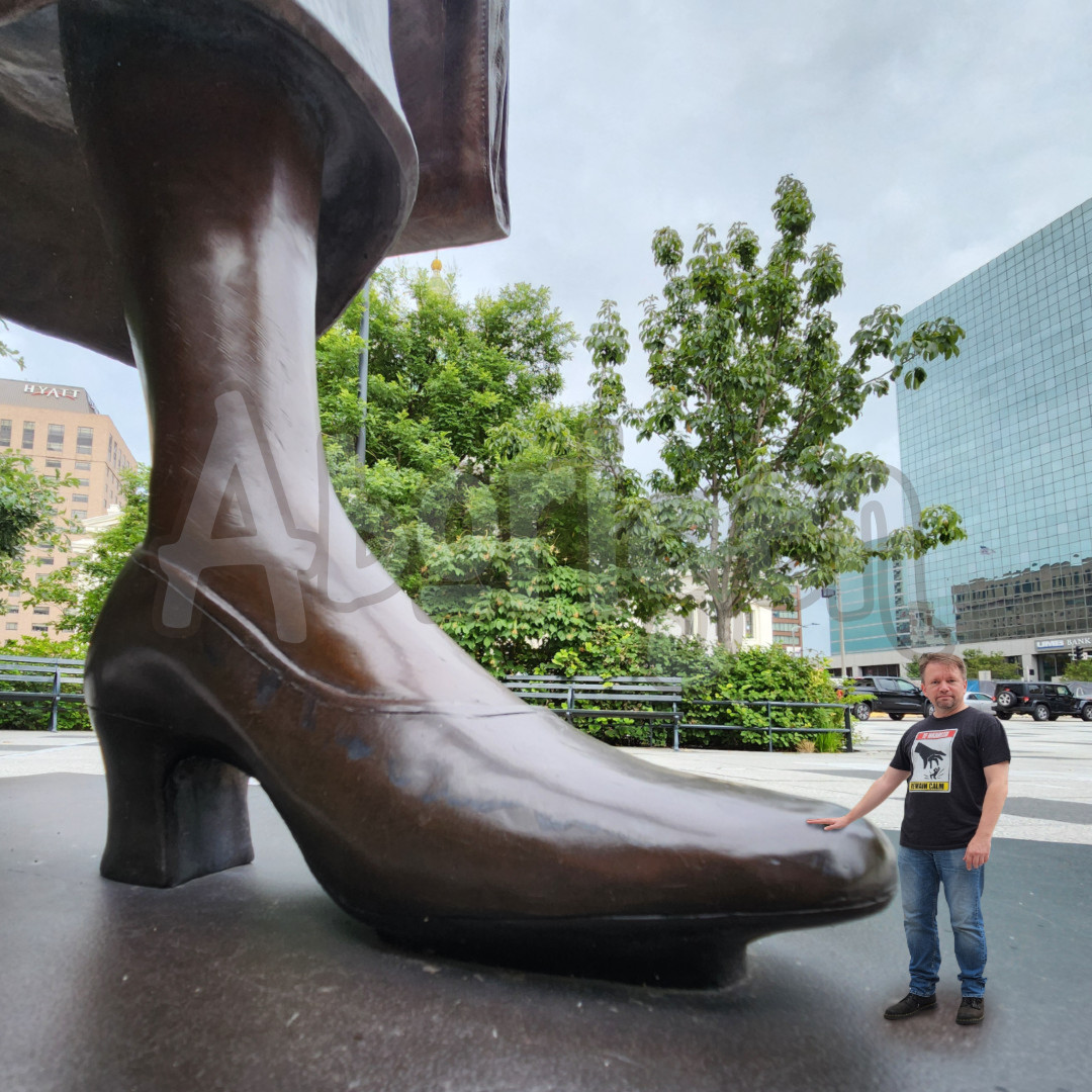 Tiny Aborigen stands by the foot of a bronze statue of Frankie Muse Freeman, attorney at law, in St Louis, Missouri.